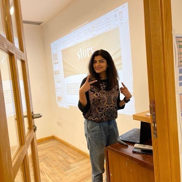 Sonia Arif standing at the projector between training sessions